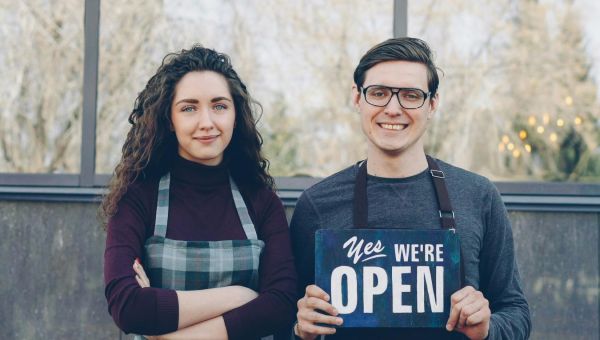 Young couple celebrating opening of their business